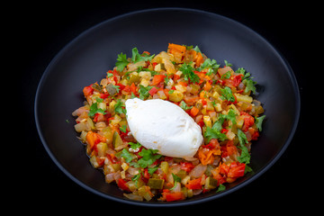 Spanish dish pisto manchego with poached egg