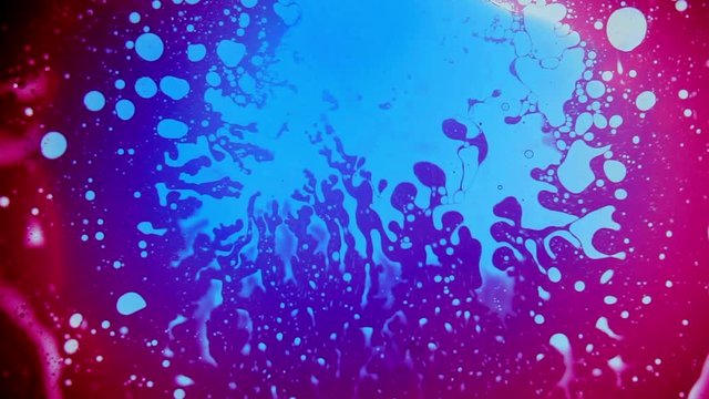 Psychedelic abstract liquid light show, weird ink patterns in water, oil, paint. Multicolor 60's disco oil wheel. Organic swirl pattern, dye explosion, kaleidoscope of colors. Bright trippy wallpaper