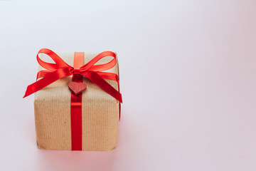  gift box with a red bow wrapped in brown paper copy space. Valentine's Day Gift.