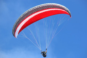 Paraglider flying wing in a blue sky	