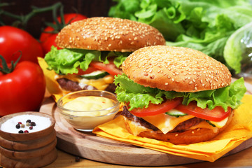 Two fresh hamburgers with vegetables