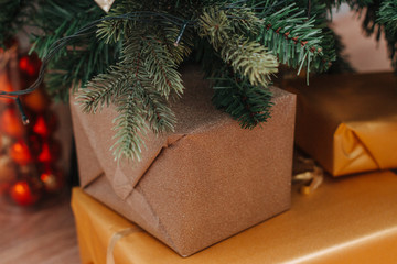 Fototapeta na wymiar Golden christmas gifts in mock up boxes under the Christmas tree