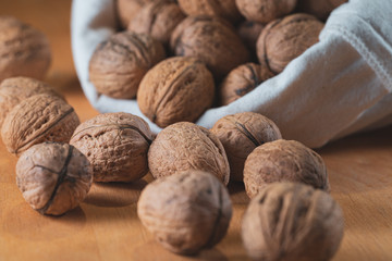 Scattered walnuts on wooden table