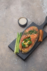 Fried salmon steak with polenta on wooden board, copy space