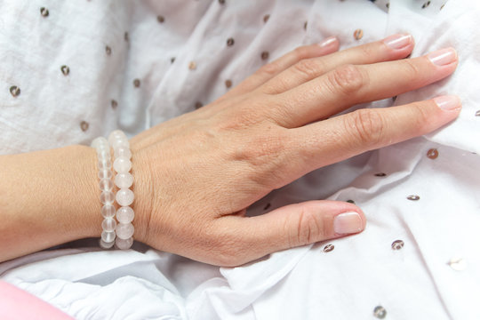 Fashion accessories. Jewelry on female hand. Gemstone bracelets. Natural stones beads.