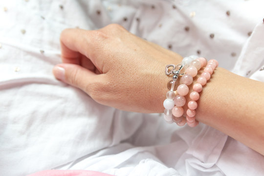 Fashion accessories. Jewelry on female hand. Gemstone bracelets. Natural stones beads.