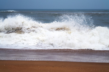 sea beach with sea water waves with Water drops and foam under blue sky in india