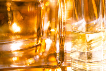 Beautiful bokeh and light reflections in yellow glass perfume bottles