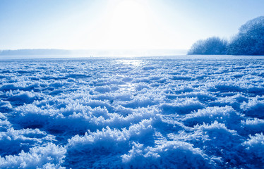 Freezing lake, winter colors, blue and white, snow crystals