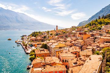 Limone Sul Garda cityscape on the shore of Garda lake surrounded by scenic Northern Italian nature....
