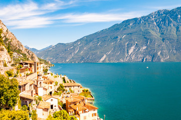 Limone Sul Garda cityscape on the shore of Garda lake surrounded by scenic Northern Italian nature....