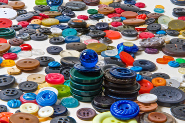 Buttons are different in color, shape, style, materials and manufacturing technology in bulk top view