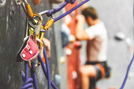 Close-up detail of rock climber wearing safety harness and climbing equipment outdoor. climbing carabiner insurance.
