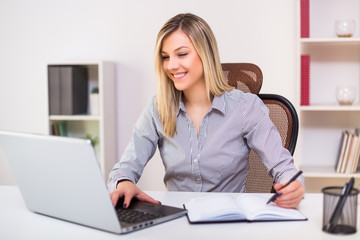 Beautiful businesswoman working at her office.	