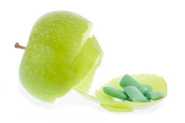 green apple and chewing gum isolated on white background