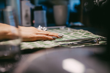 Woman in a nail salon receiving a manicure by a beautician