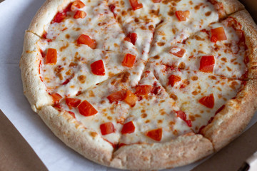 Vegetarian pizza with cheese and pepper in a box