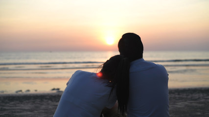 Holiday concept. Young lovers making heart-shaped hands on the beach. 4k Resolution.