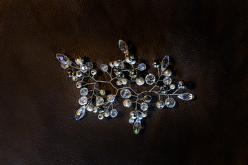 Handmade bead jewelry. Decorations for wedding hairstyles and any celebration in the form of twigs. Ornament on the background of dark skin.