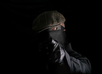 Fototapeta na wymiar masked intruder is pointing a finger at you