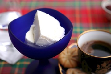 Cold ice cream in cups dark blue, teaspoon, raspberry jam