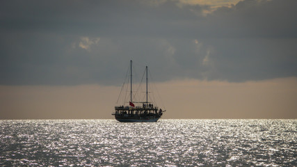 sailing ship on the horizon against the sunset sky