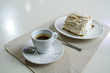 A delicious roll of bezrukov and a cup of coffee on a table in a cozy coffee shop