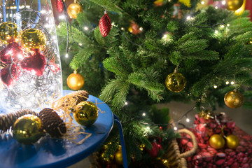 Fototapeta na wymiar beautiful decorated Christmas tree with ornaments and lights and presents underneath and baubles in vase