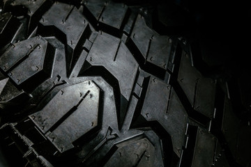 Grooves detail of a black rugged terrain tire for heavy duty offroad cars and trucks