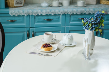 Danish with cherries and black tea on a table in a cozy coffee shop
