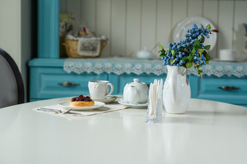 Danish with cherries and black tea on a table in a cozy coffee shop