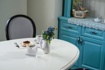 Danish with cherries and black tea on a table in a cozy coffee shop