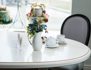 Danish with cherries and black tea on a table in a cozy coffee shop