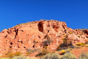 Fototapeta premium Red Cliffs National Conservation Area Wilderness and Snow Canyon State Park from the Elephant Arch and bone wash Trail by St George, Utah in desert reserve. United States. USA.
