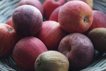 red apples in a wooden design basket