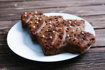 Homemade Christmas cake in the shape of a Christmas tree on a wooden table