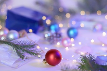 Christmas decor, spruce branches, illumination on a light background, season winter greetings, festive interior details