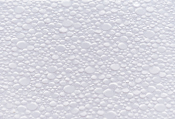 Texture of white ceramic tiles with volumetric small stones.