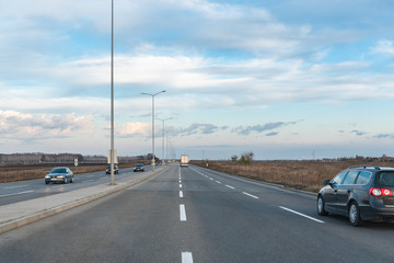 Fototapeta premium vehicles are moving along the road, view from the car