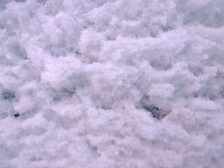 Background of white fluffy snow. Place for text. Copy space. Winter is here. Frosty cold weather. Snowfall in the city. Concept of ecology and clean fresh air. Wallpaper.