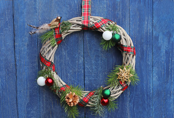 Christmas wreath hanging on an old wooden wall