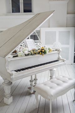 White piano in white room. play music.