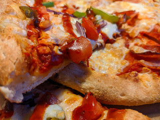 Sliced ​​pizza with mozzarella cheese, tomatoes, peppers, spices and fresh basil. Italian pizza. Pizza Margarita or Margarita.