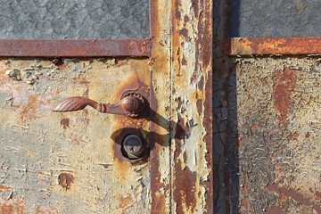 Closeup of old rusty metal lock and keyhole on a old iron door as a beautiful vintage background. Fragment of old rusty gate.