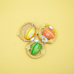 Easter theme. Decorated Easter eggs on a yellow background. Minimalism, View from above, flat lay