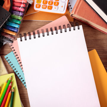 Busy student's desk with blank sketch pad