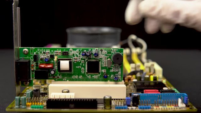 Installing a network card on the motherboard. Network data transmission system via wire. Many different chips. View of the computer parsed