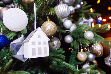 Decorated Christmas tree with house toy