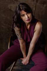 Fototapeta premium Beautiful young woman wearing marsala jumpsuit