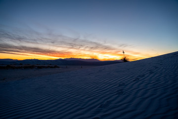 The sun sets over the dunes at White Sands New Mexico. 
